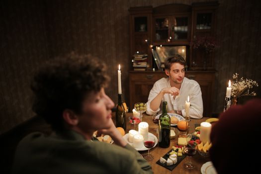 Man in White Dress Shirt Sitting Beside Woman in White Long Sleeve Shirt