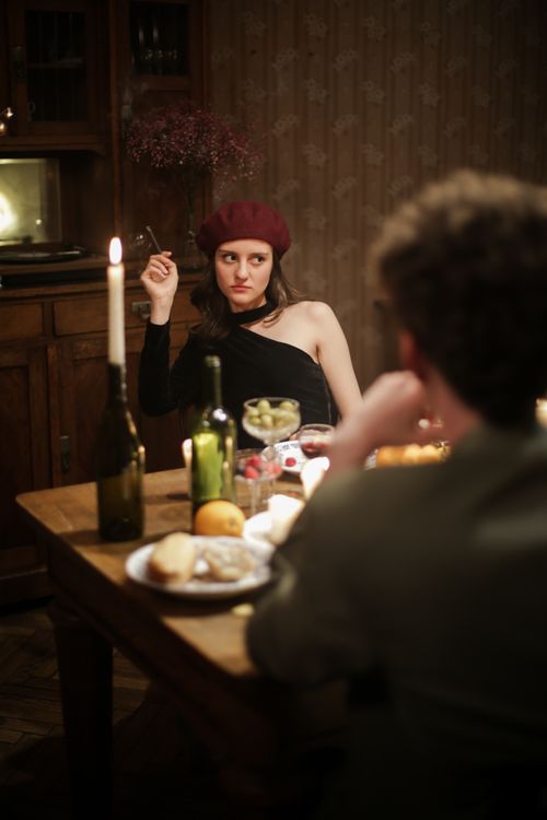 Free Elegant candlelit dinner with a couple, evoking a Parisian night vibe. Stock Photo
