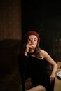 Woman in Black Spaghetti Strap Top Wearing Red Cap