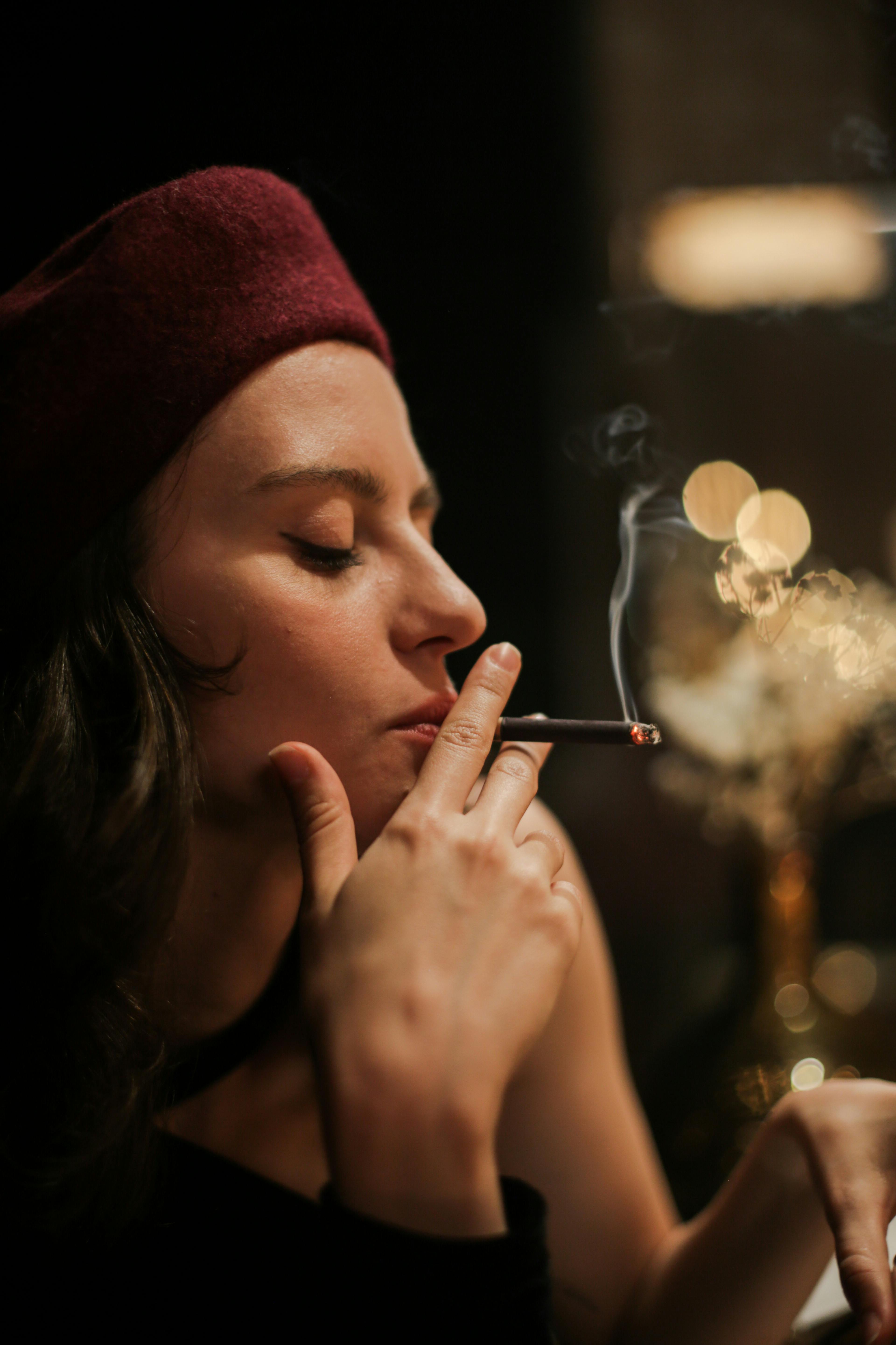 Woman in Red Knit Cap Smoking Cigarette · Free Stock Photo