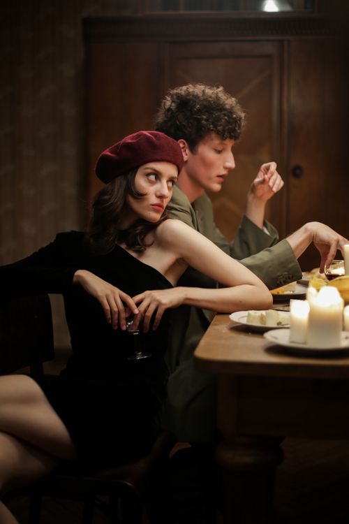 Free Couple enjoying a candlelit dinner with a romantic ambiance. Stock Photo