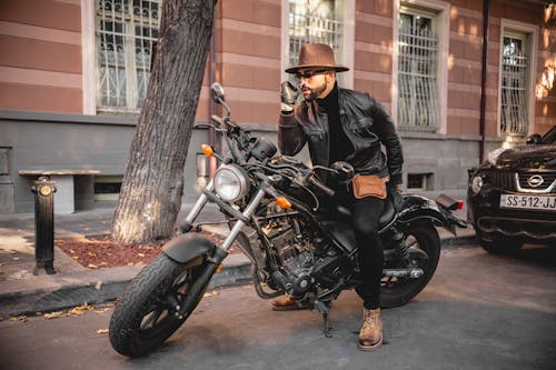 Free A Fashionable Man Sitting on a Motorcycle Stock Photo
