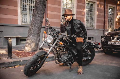 A Fashionable Man Sitting on a Motorcycle