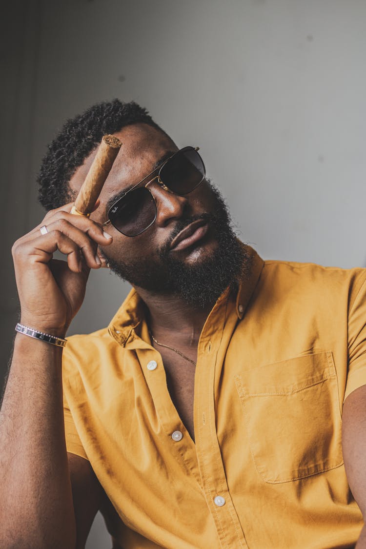 Stylish Masculine Black Man With Cigar On Gray Background