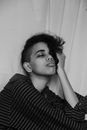 Grayscale Photo of a Woman in Striped Long Sleeve Shirt Pouting