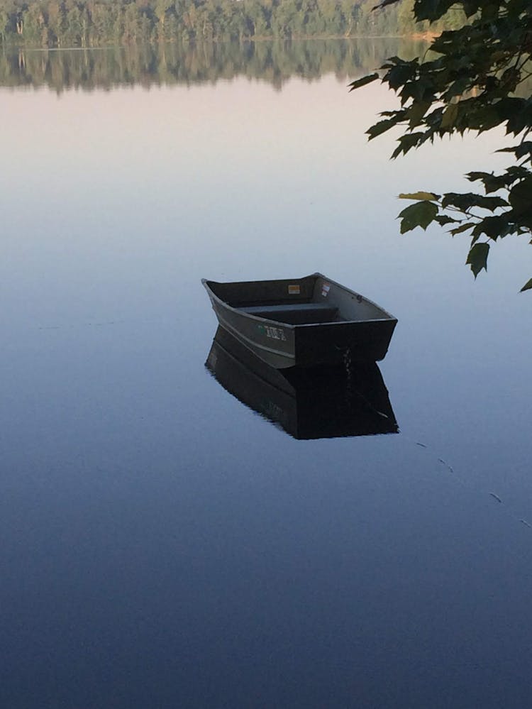 A Boat Floating In The Lake