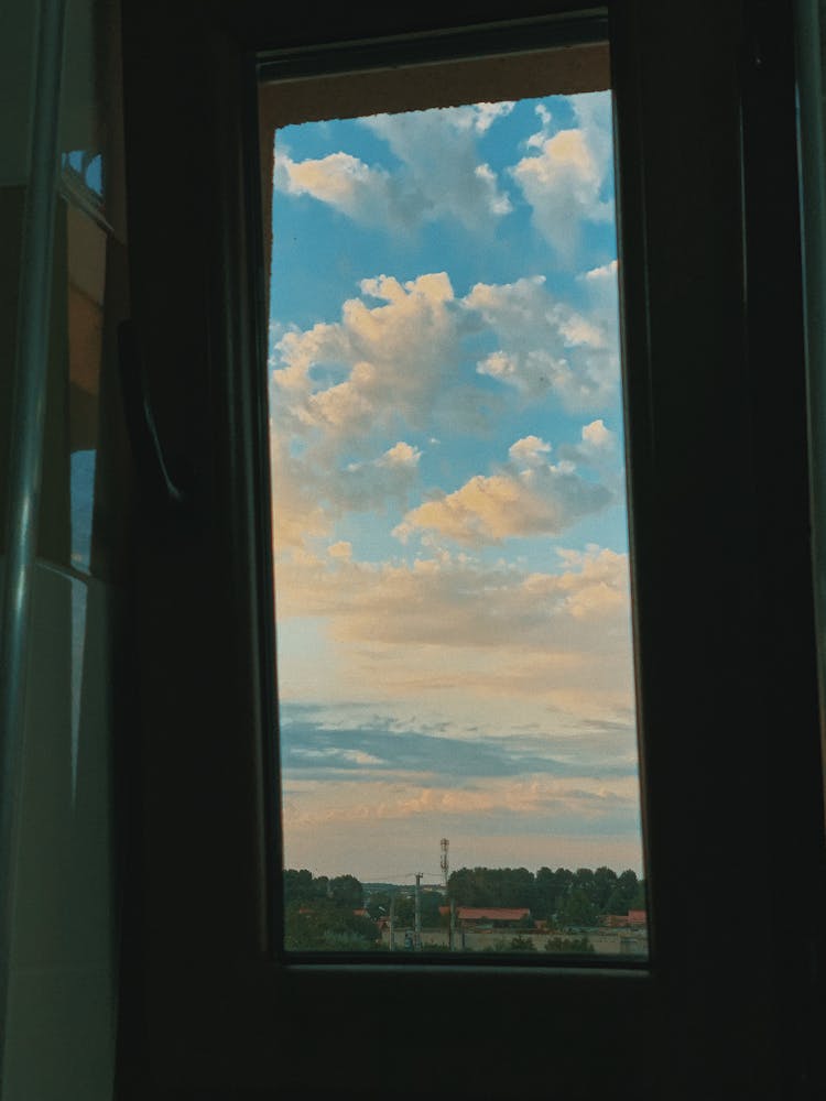 Countryside With Fluffy Clouds Through Window