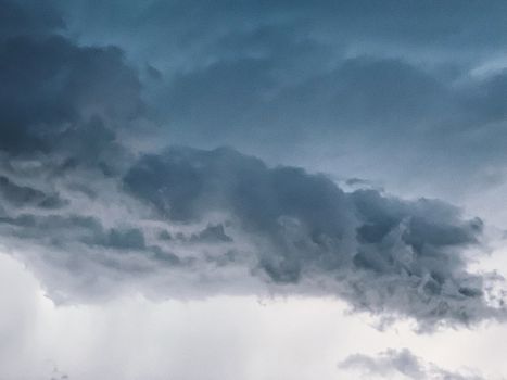 Nature background of dramatic sky with cumulus dark clouds floating in overcast weather before thunderstorm