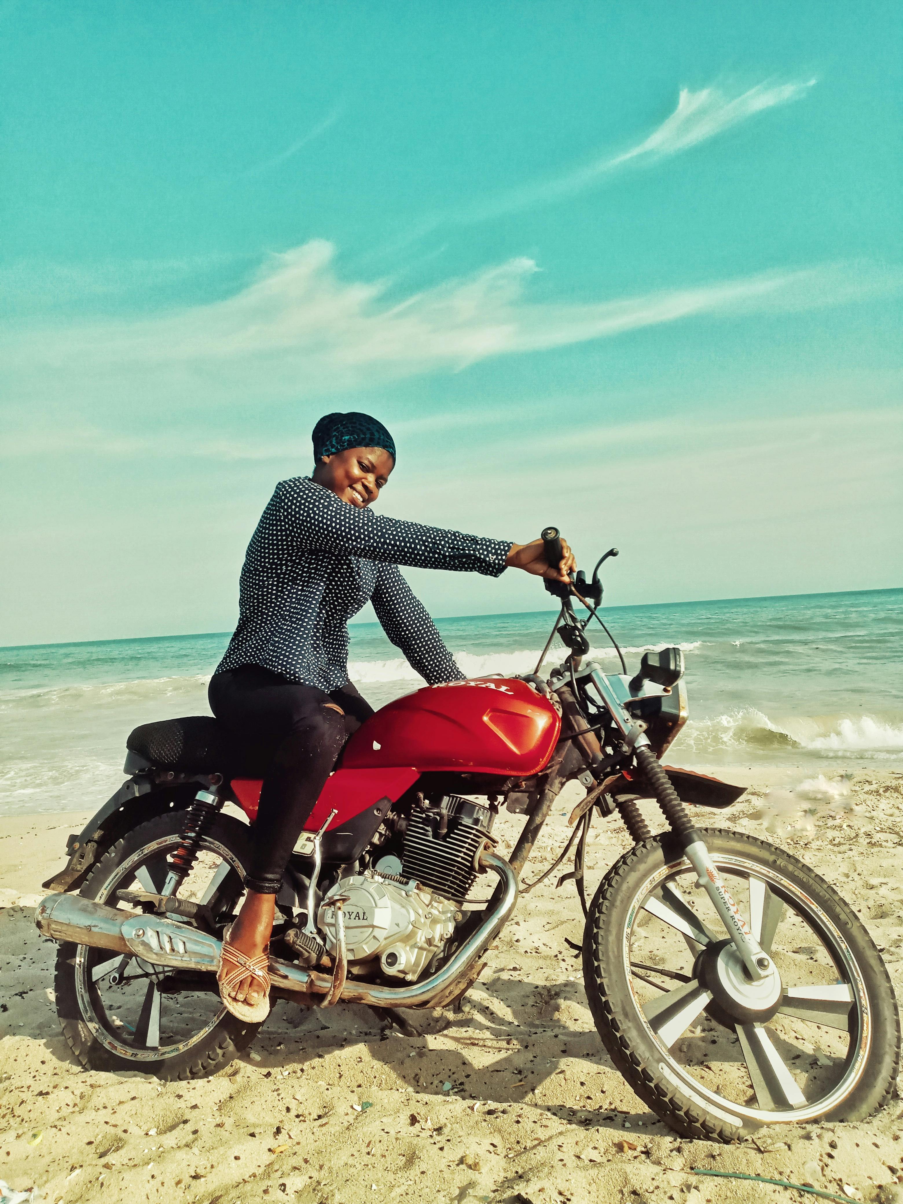 A Beautiful Woman Sitting on a Dirt Bike · Free Stock Photo