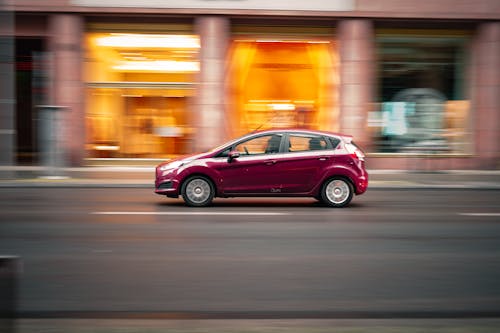 A Car Driving on the Concrete Road