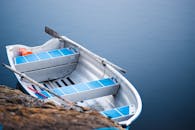 White and Blue Boat on Body of Water