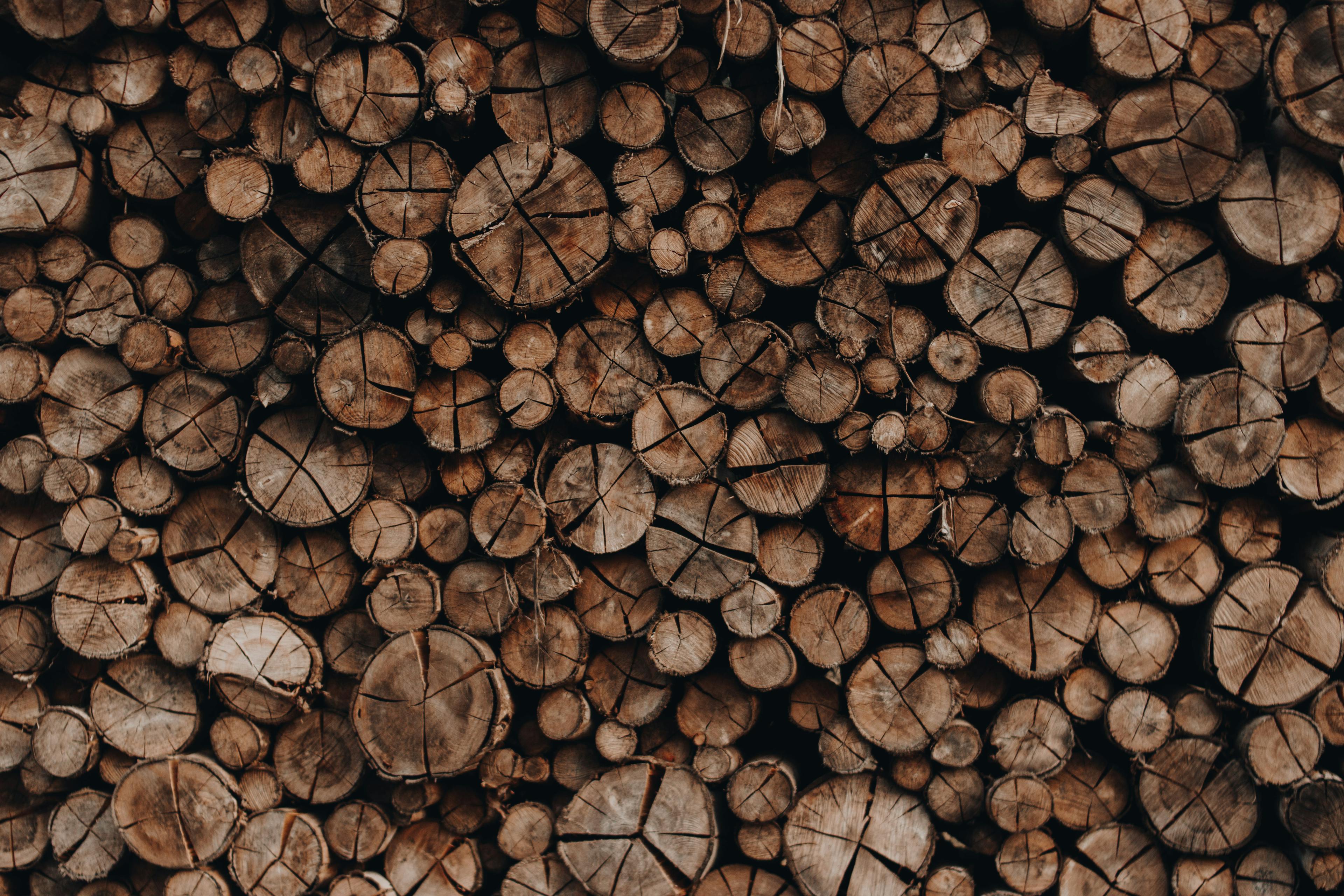 Pile of wooden skids with cracks stacked accurately in rows arranged for cutting