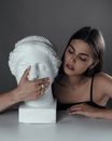 Young woman with bust sculpture