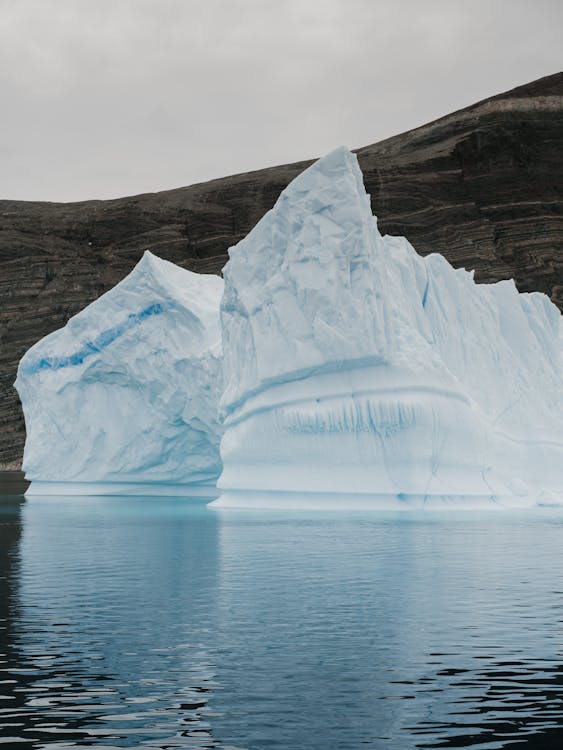 Mountain and Iceberg on Body of Water