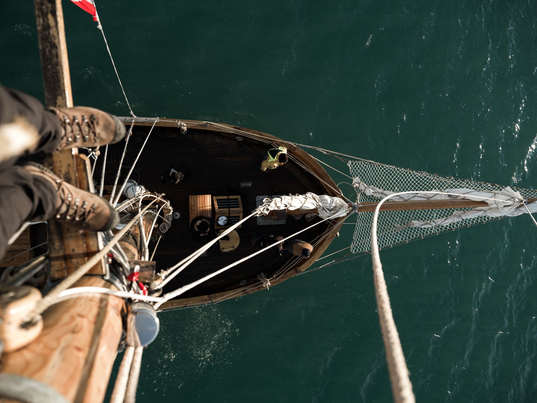 High-angle shot of a sailboat navigating through open waters. Perfect for travel and adventure themes.