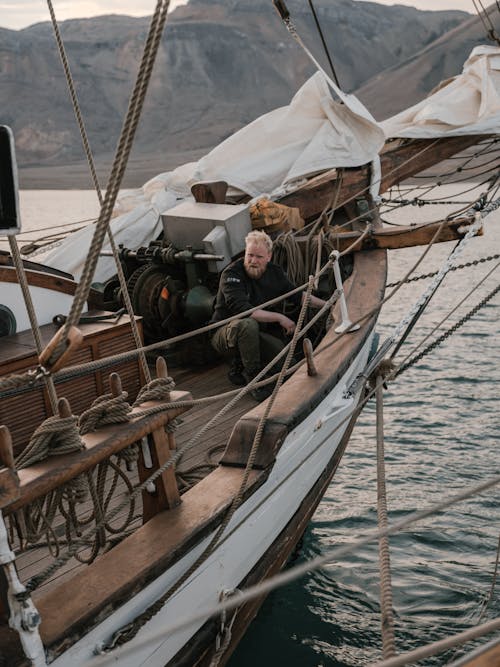 Free Man Sitting on the Ship Stock Photo