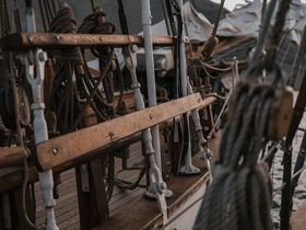 Coiled ropes and pulleys on a wooden ship deck — photo by ArtHouse Studio on Pexels