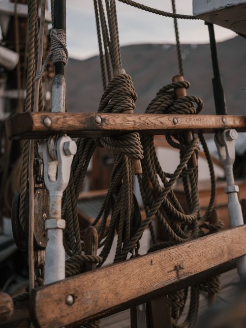 Free Detailed view of a sailboat's rigging and ropes, showcasing nautical craftsmanship. Stock Photo