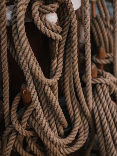 Detailed close-up of coiled nautical ropes on a wooden boat deck.
