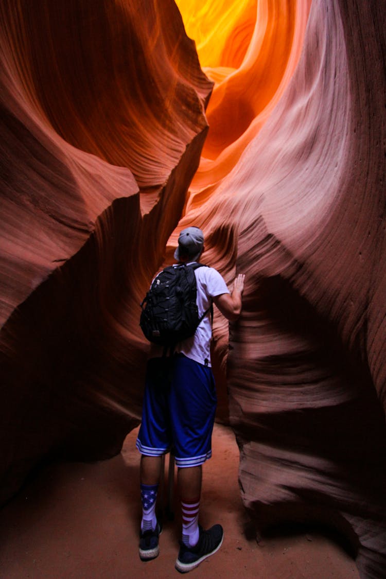 Back View Of A Person Exploring A Canyon