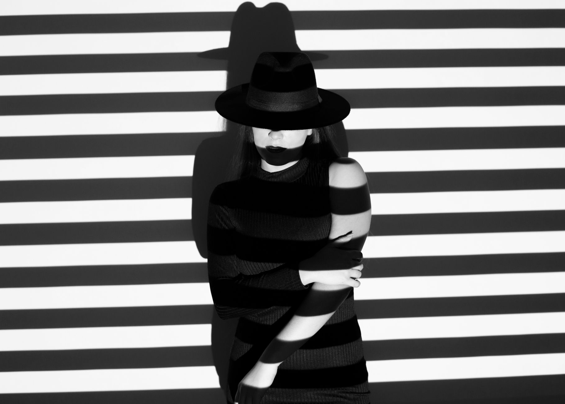 Crop woman in striped projector light