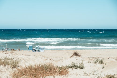 Free Chairs on Sandy Beach and Turquoise Sea Stock Photo