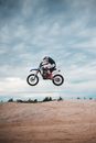 Unrecognizable biker doing trick in air