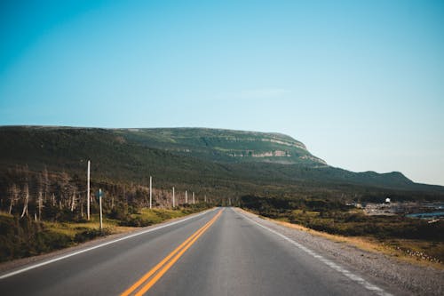 Asphalt road leading to mountain