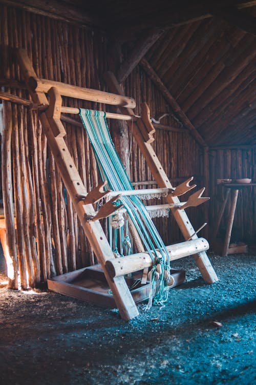 Aged wooden loom with weaved yarn