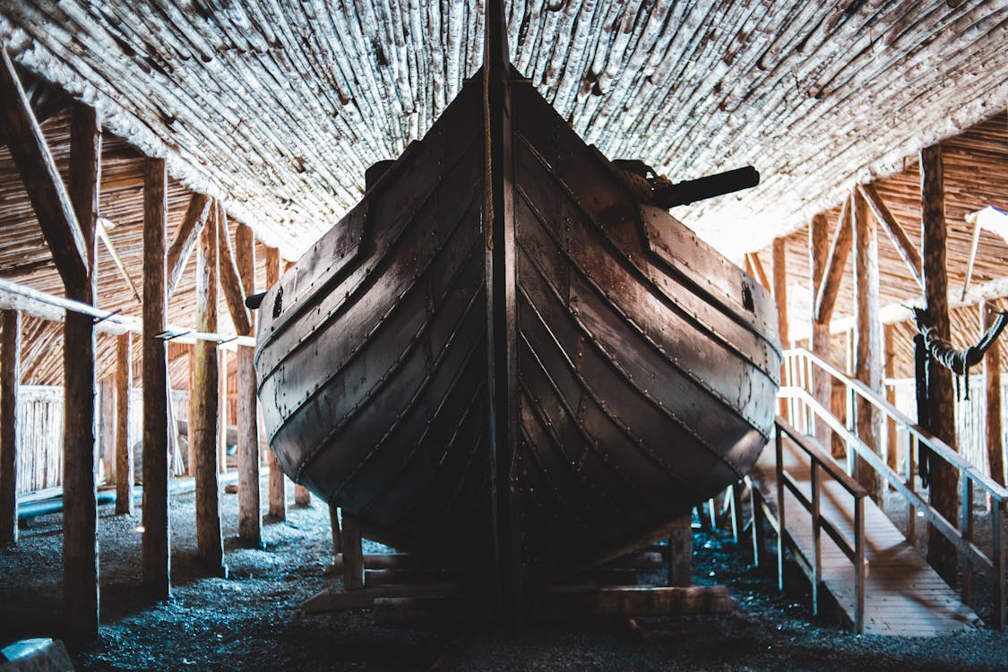 Traditional wooden Viking boat in aged village