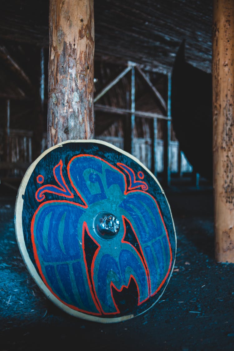 Painted Round Shield In Wooden House