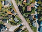 Drone view of housetops along roadway in settlement