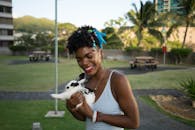 Black smiling woman hugging cute rabbit