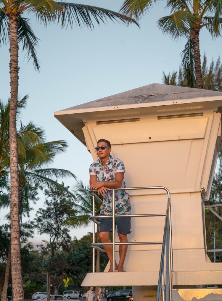 Tanned Man In Sunglasses Standing On Safeguard Tower