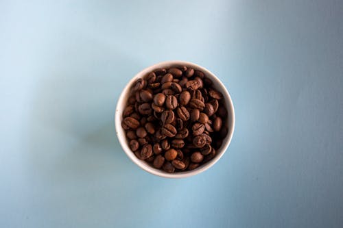 White Ceramic Bowl With Brown Coffee Beans