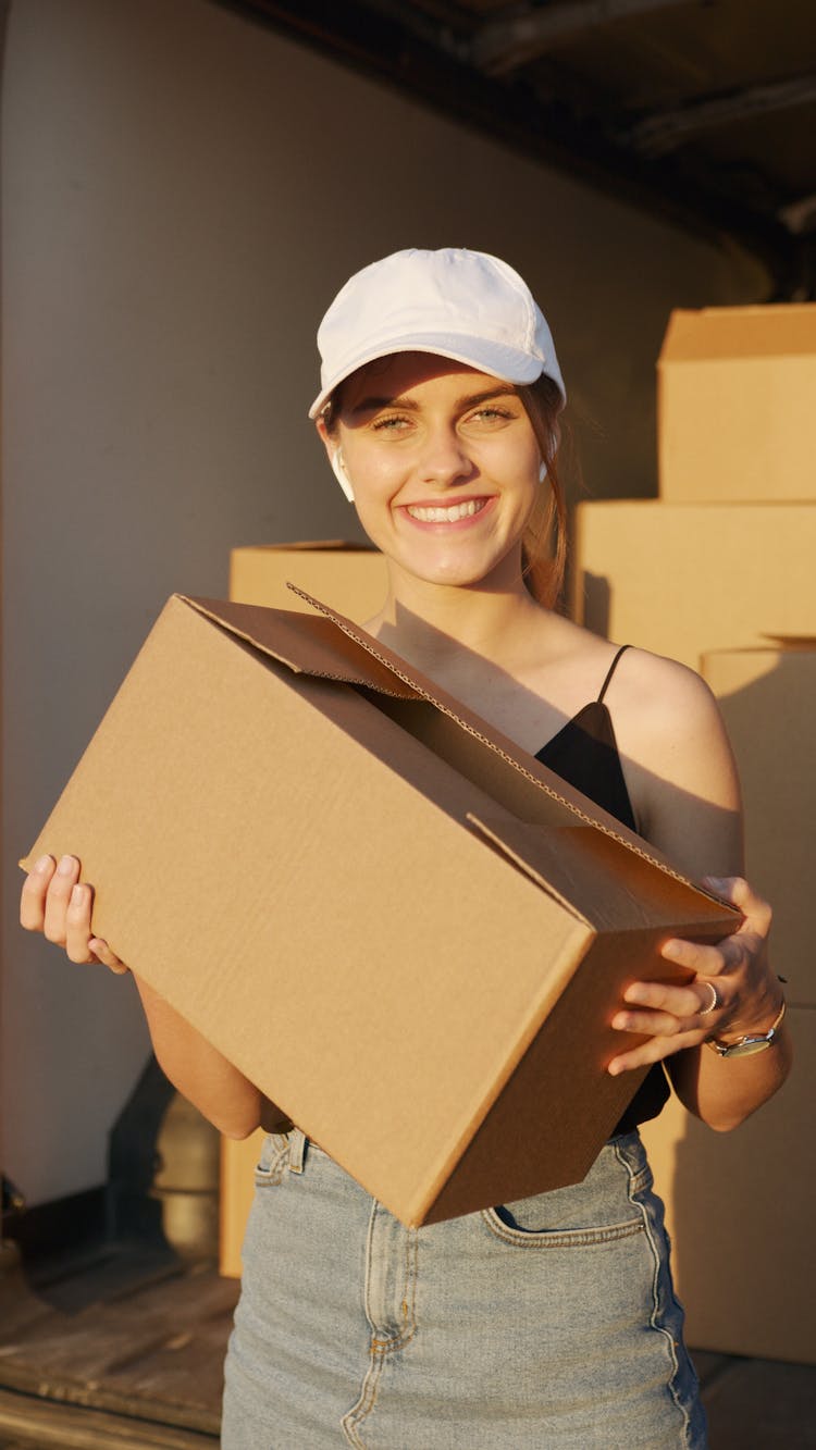 Woman Smiling While Holding A Box