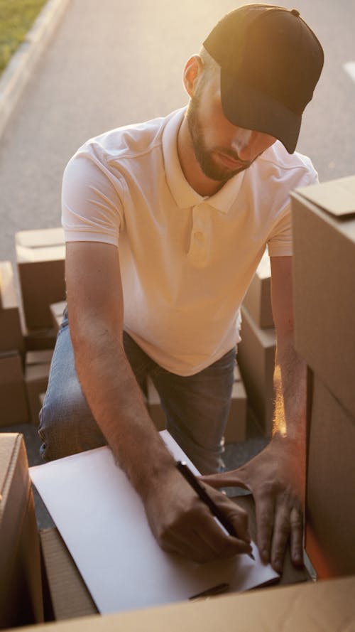 Man Writing on Paper