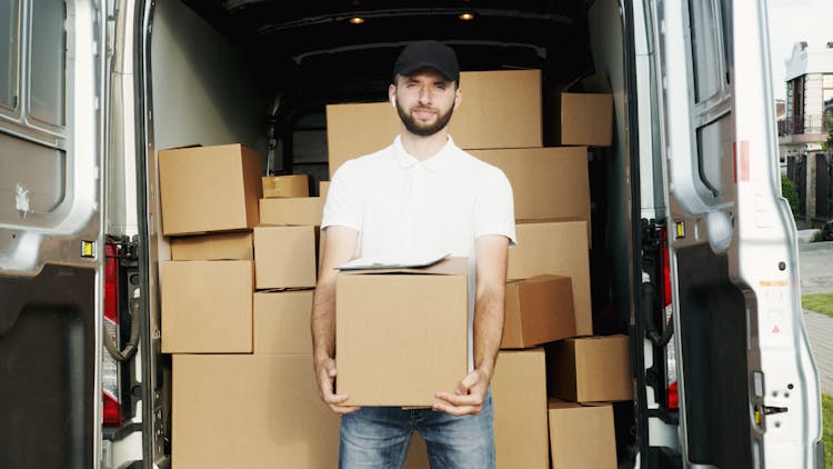 Man Smiling While Holding A Box