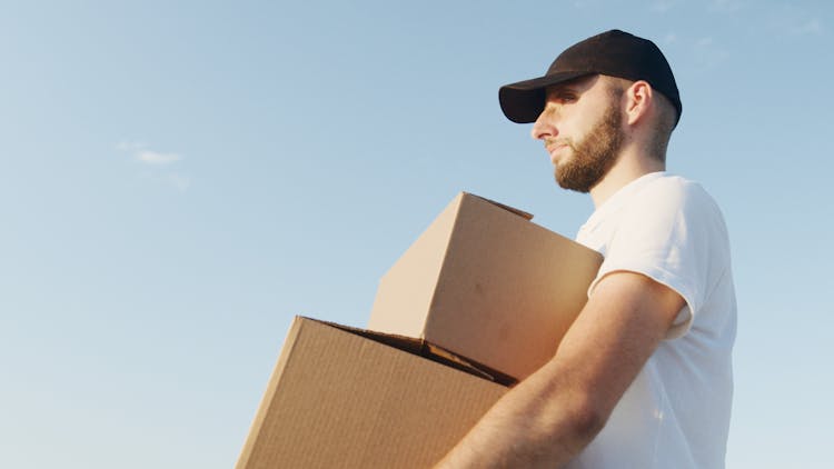 Man With Beard Carrying Cardboard Boxes