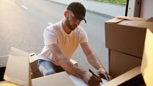 Free Man Checking on Parcel Deliveries Stock Photo