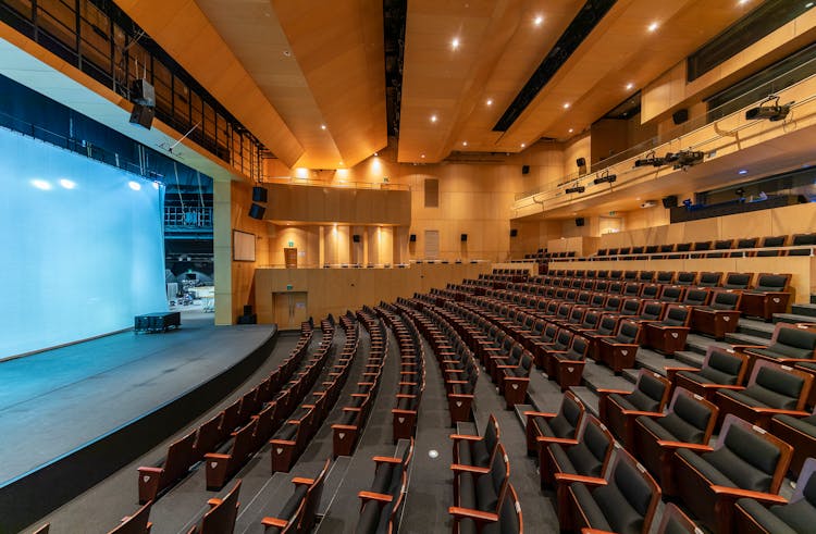 Empty Concert Hall With Rows Of Chairs