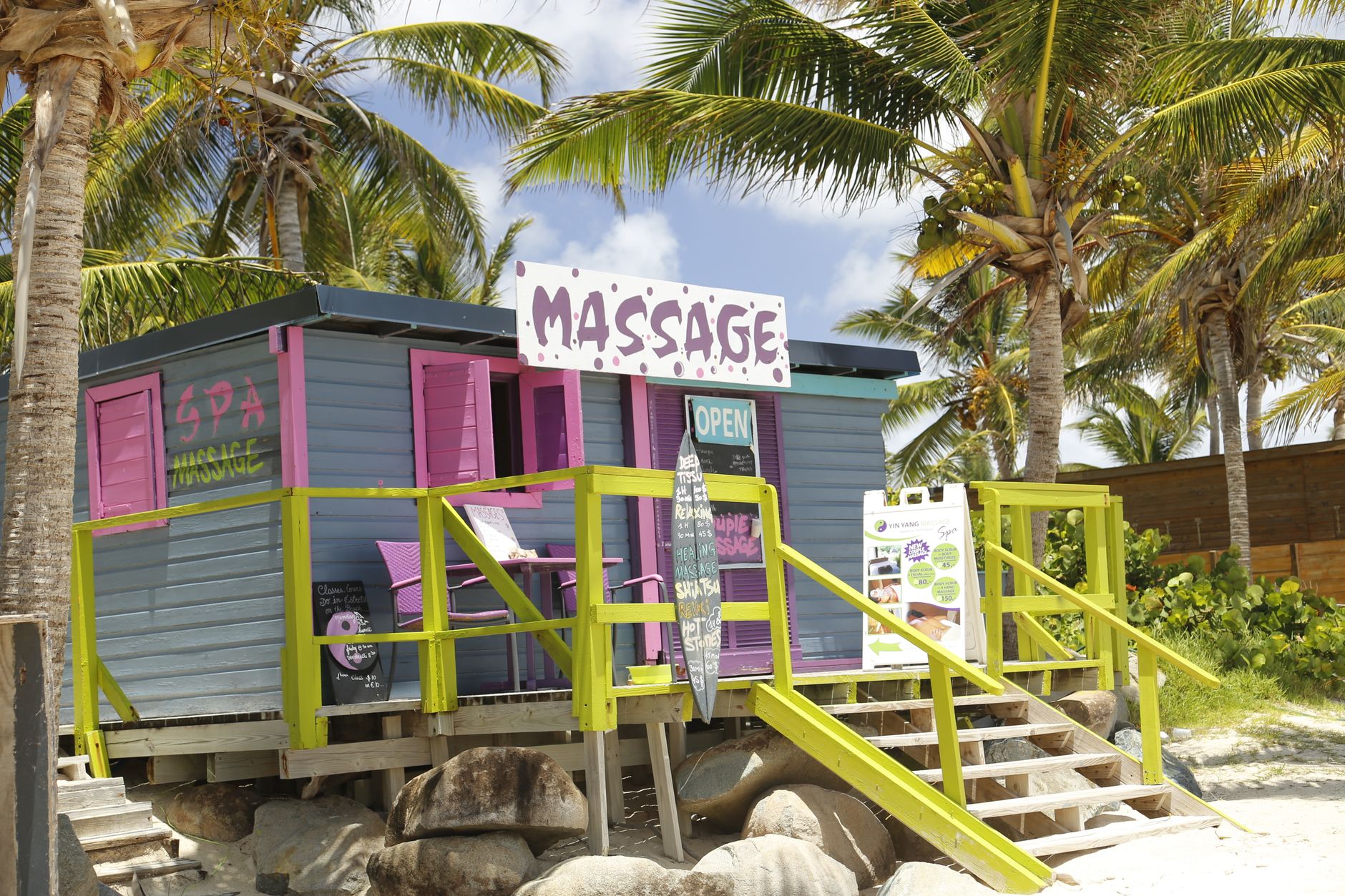 A vibrant beachside spa shack surrounded by palm trees in Saint Martin.. Photo by Dariusz Domagalski on Pexels