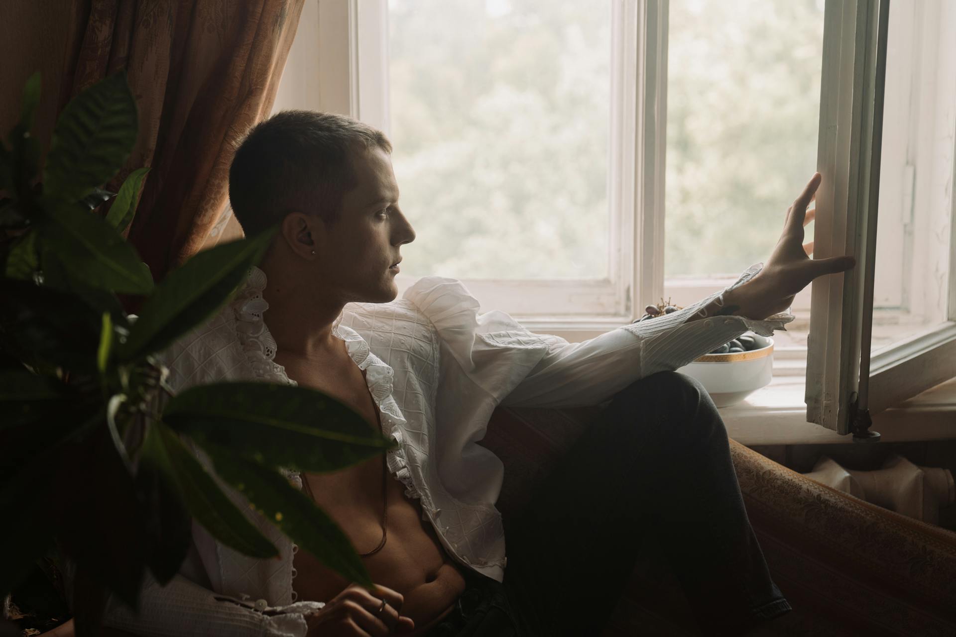 Man in White Dress Shirt Sitting on Bed