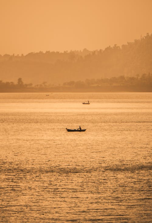 Person Riding on Boat on Sea