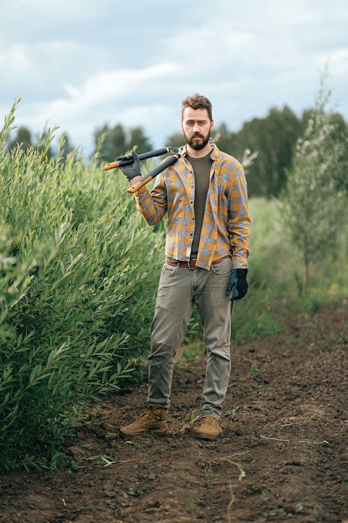 A Man Standing while Holding Shears