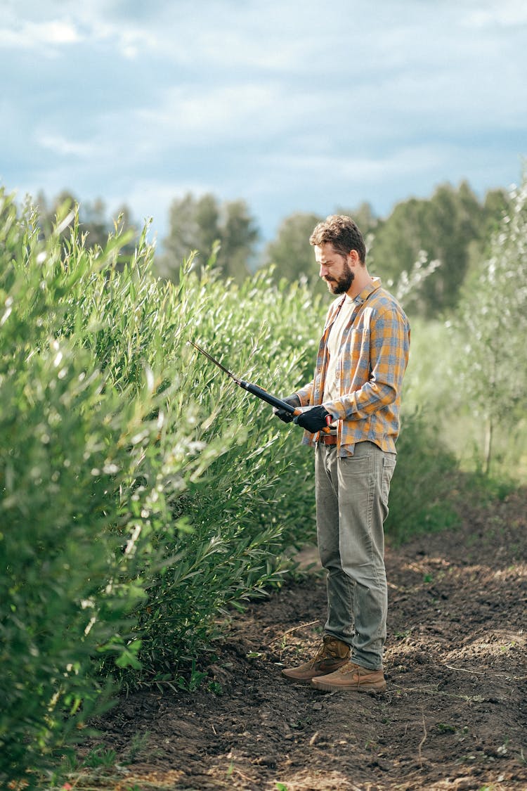 A Man Standing While Holding Shears