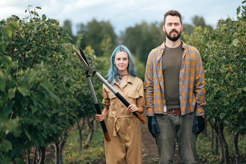 A Woman Holding Shears while Standing beside a Man