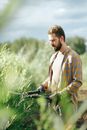 A Man Standing while Holding Shears