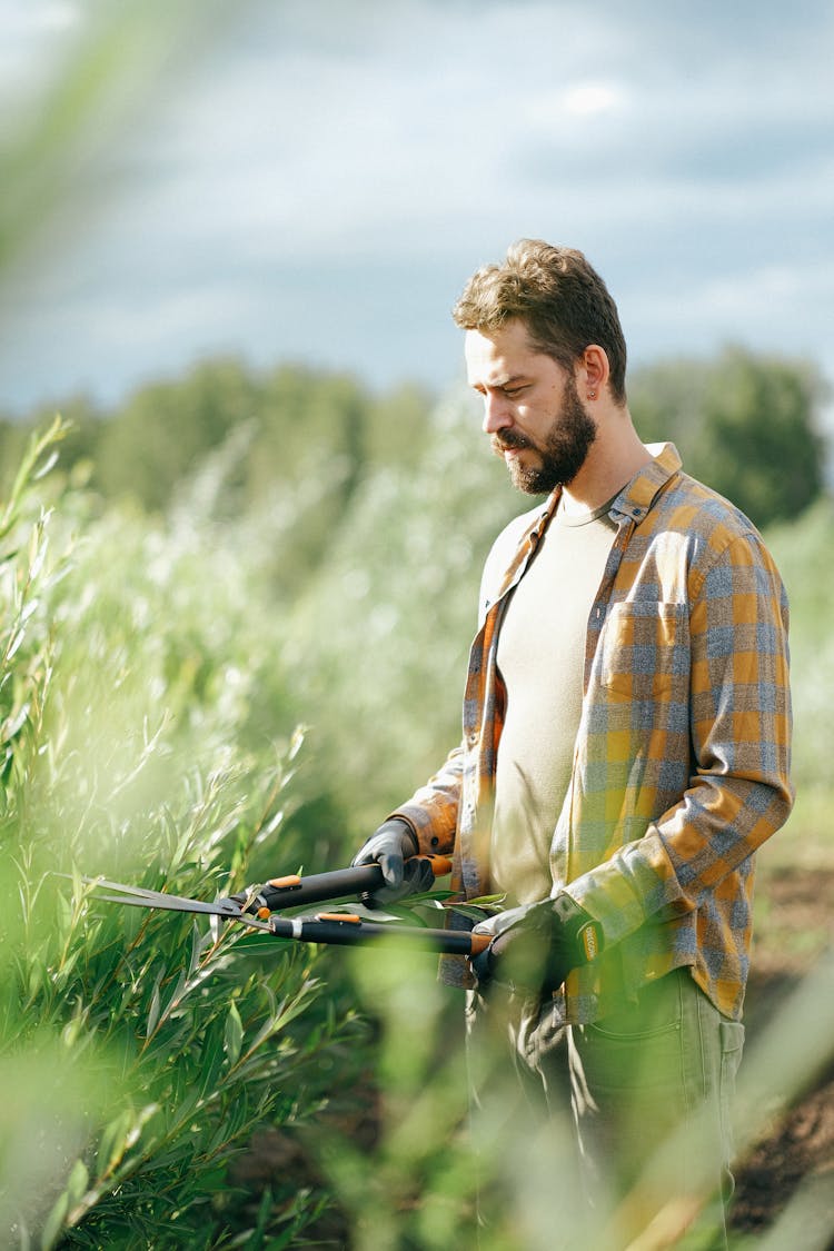 A Man Standing While Holding Shears