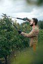 Man Using Shears to Trim Leaves